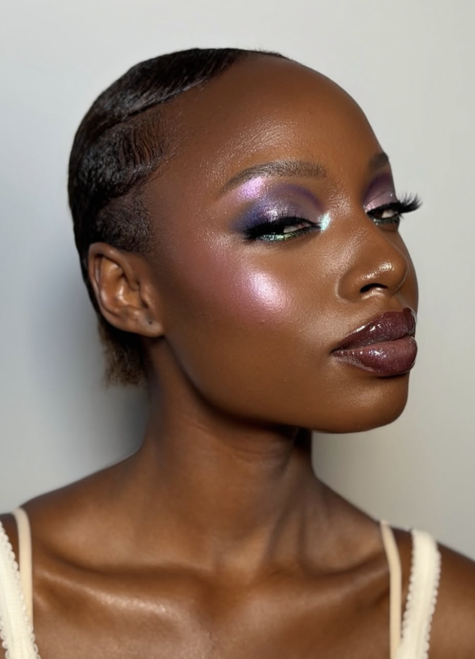 Muted plum blush swept high on the cheekbones