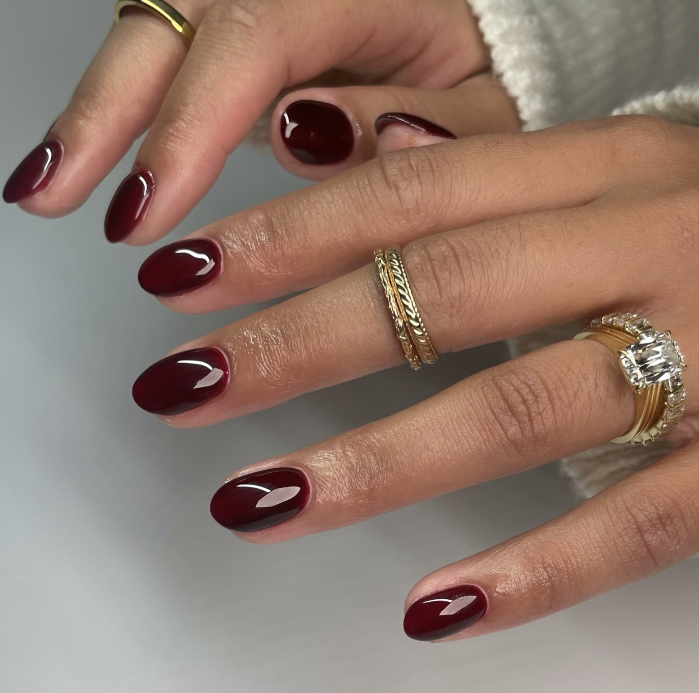 Oxblood red nail polish on short squoval nails