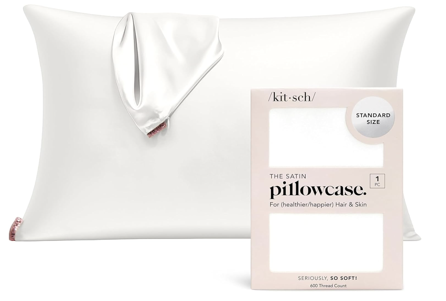 Kitsch satin pillowcase with zipper closure displayed next to its original blush pink packaging.