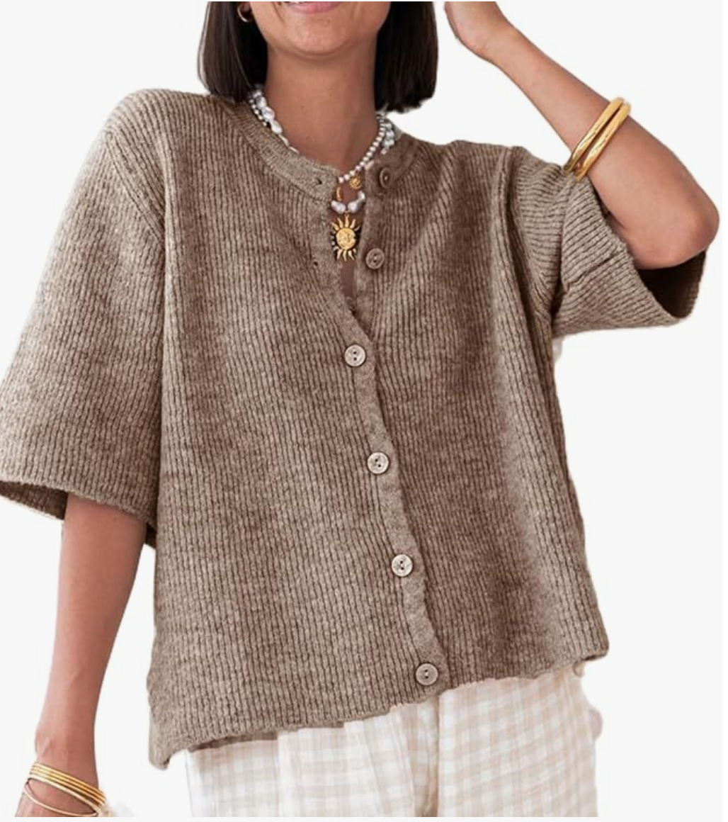 A woman wearing a taupe short-sleeve button-down cardigan paired with neutral patterned trousers, showcasing a professional and comfortable work outfit.