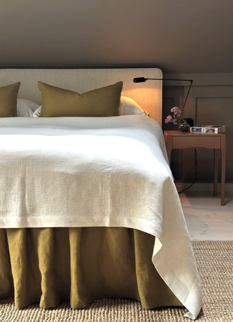 Pleated lampshade and tailored bed skirt in a fall 2026 bedroom