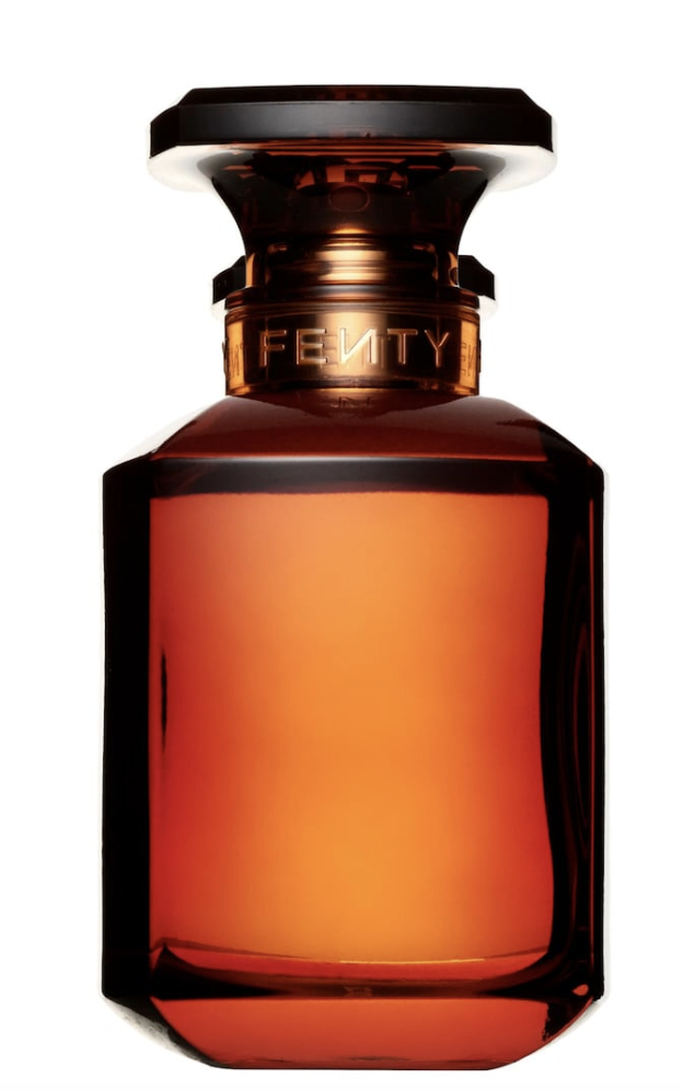 Fenty Eau de Parfum by Rihanna in a warm amber-brown glass bottle, a luxury fragrance for melanin-rich skin featuring a complex blend of magnolia, musk, and Bulgarian rose