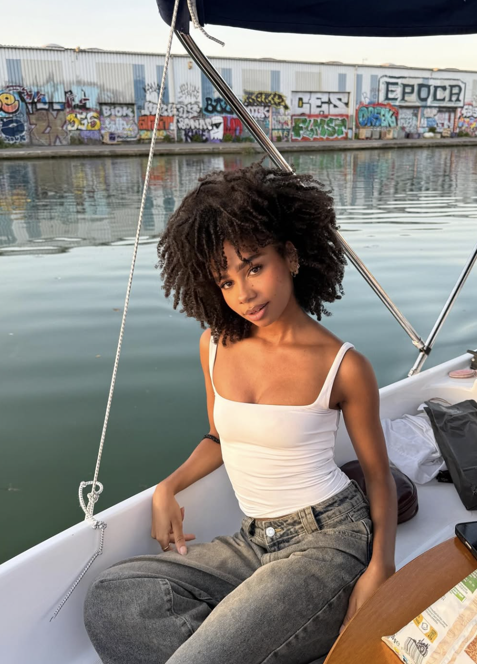 Sarah Biii featuring a full, rounded natural afro that adds width to the forehead and chin, perfectly balancing the sharp cheekbones of a diamond face shape.