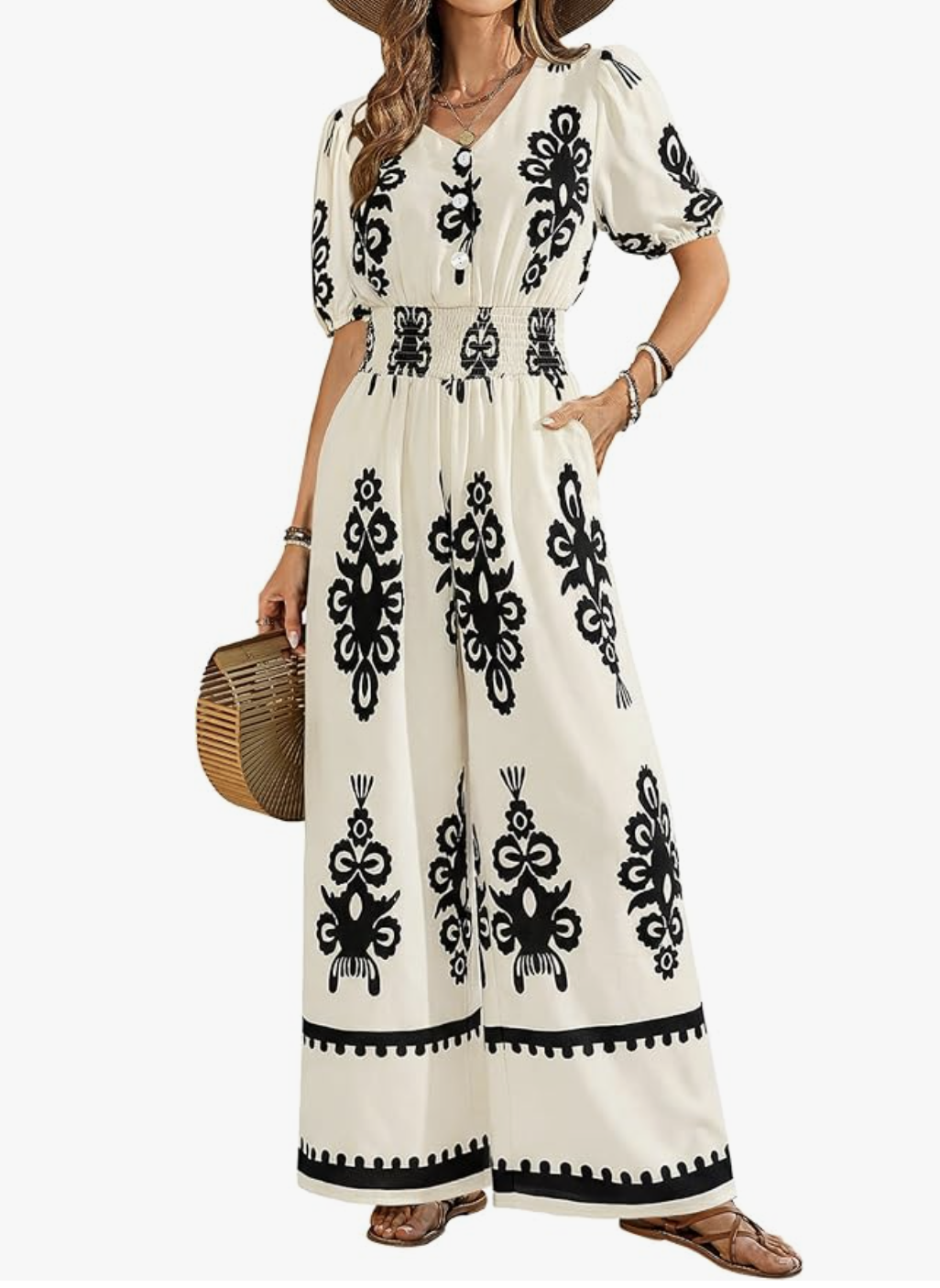 A woman wearing a black and white floral print maxi skirt with a matching tie-front top, styled as an elegant and breathable evening outfit for a cruise.