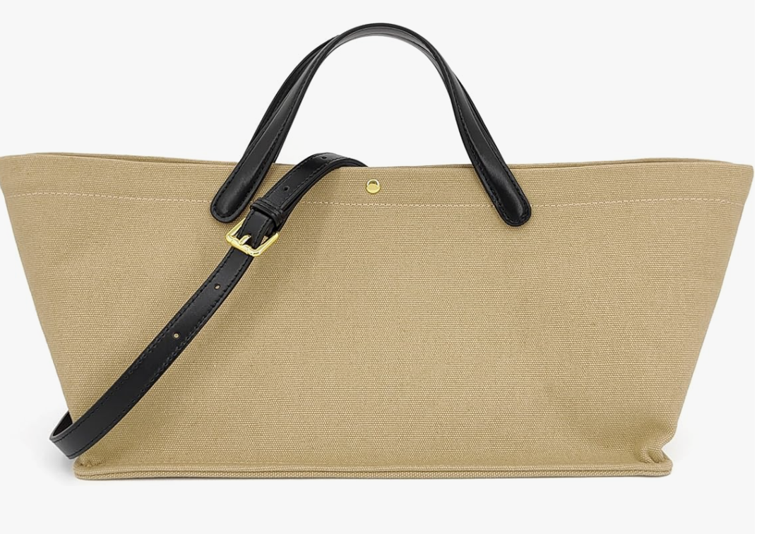 A large beige canvas tote bag with black leather straps and a gold button closure, styled as a functional accessory for a summer BBQ outfit.