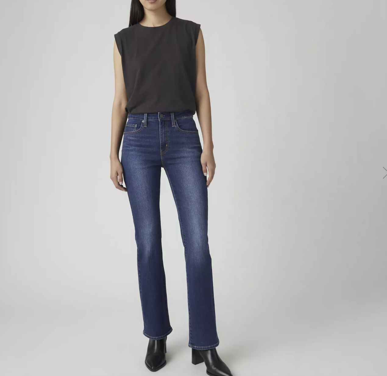 Model wearing Hudson Barbara High-Rise Bootcut Jeans in a dark wash, featuring a high-rise waist and a classic bootcut flare that provides visual balance for an athletic or rectangle figure.