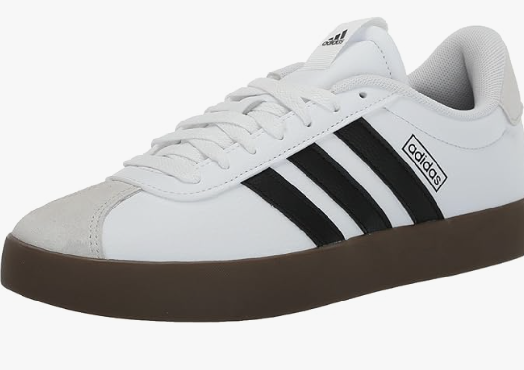 A pair of white adidas VL Court 3.0 sneakers with black stripes and a brown gum sole, styled as a casual footwear option for denim dresses.