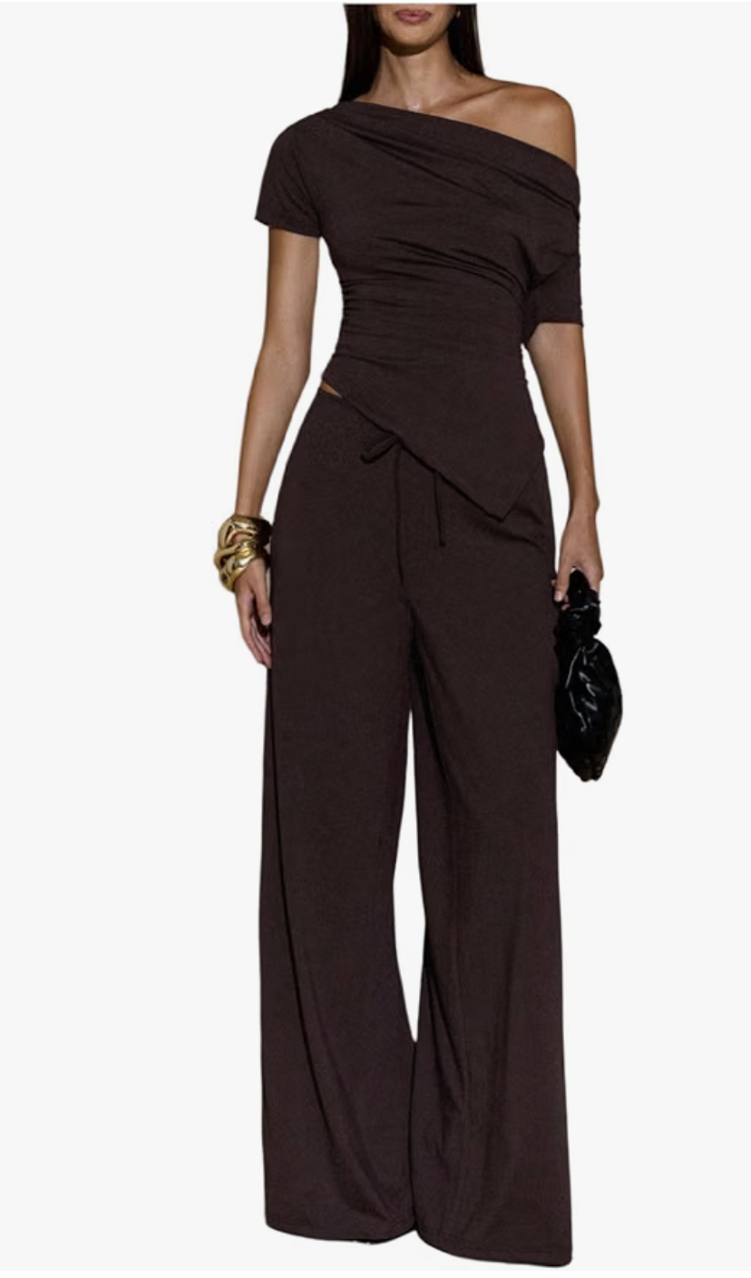 Woman wearing an Amazon chocolate brown two-piece set featuring a one-shoulder asymmetrical top and matching wide-leg trousers