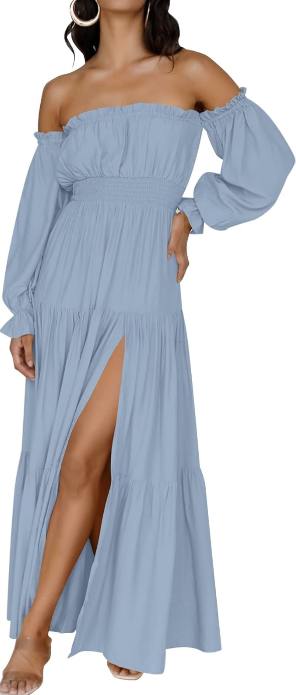 A close-up of a person wearing a dusty blue off-the-shoulder maxi dress with long sleeves, a high thigh slit, and clear strap sandal heels.