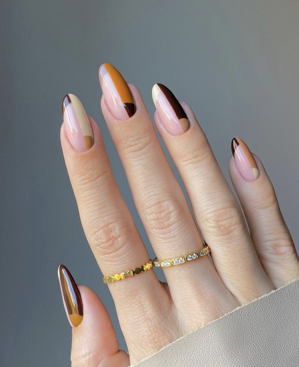 Close-up of mixed autumn-color french on neatly manicured hands