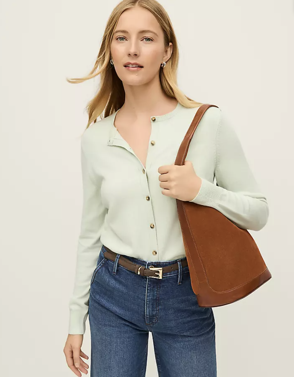 A professional stylist's pick: the Ann Taylor Ann Cardigan in light mint green with gold buttons and contrast trim, styled with high-waist jeans and a brown leather bag.