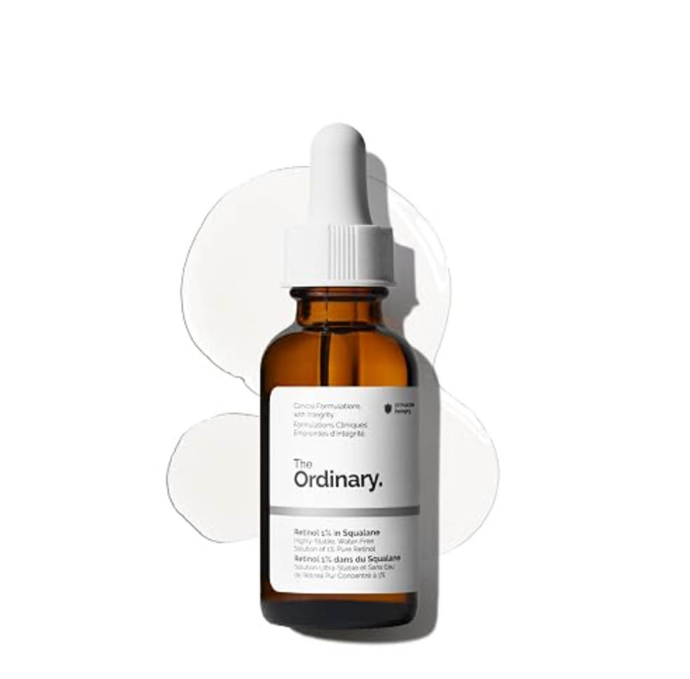 Amber dropper bottle of The Ordinary Retinol 1% in Squalane over a white serum swatch.