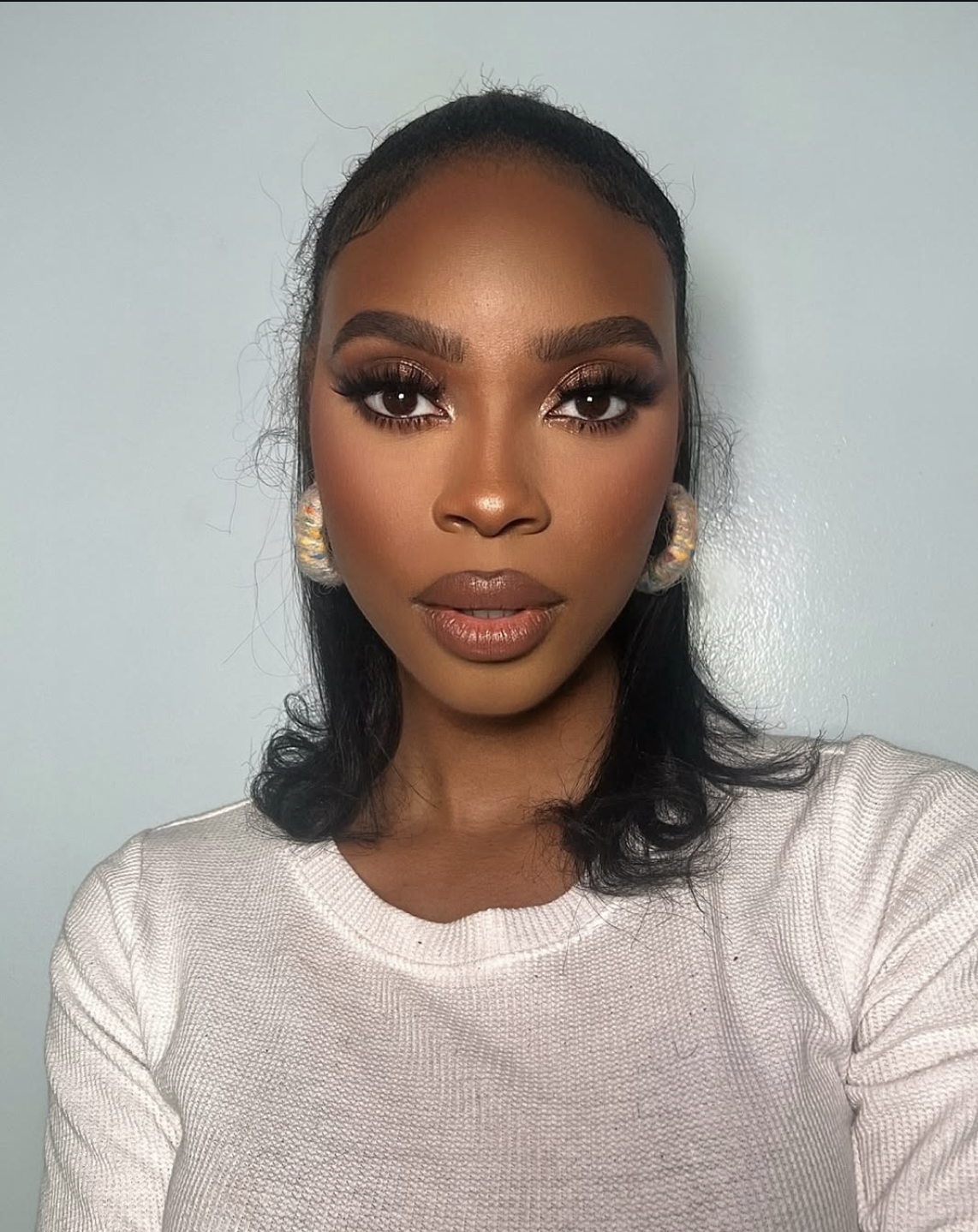 Woman wearing coordinated chocolate-brown eye, cheek and lip makeup