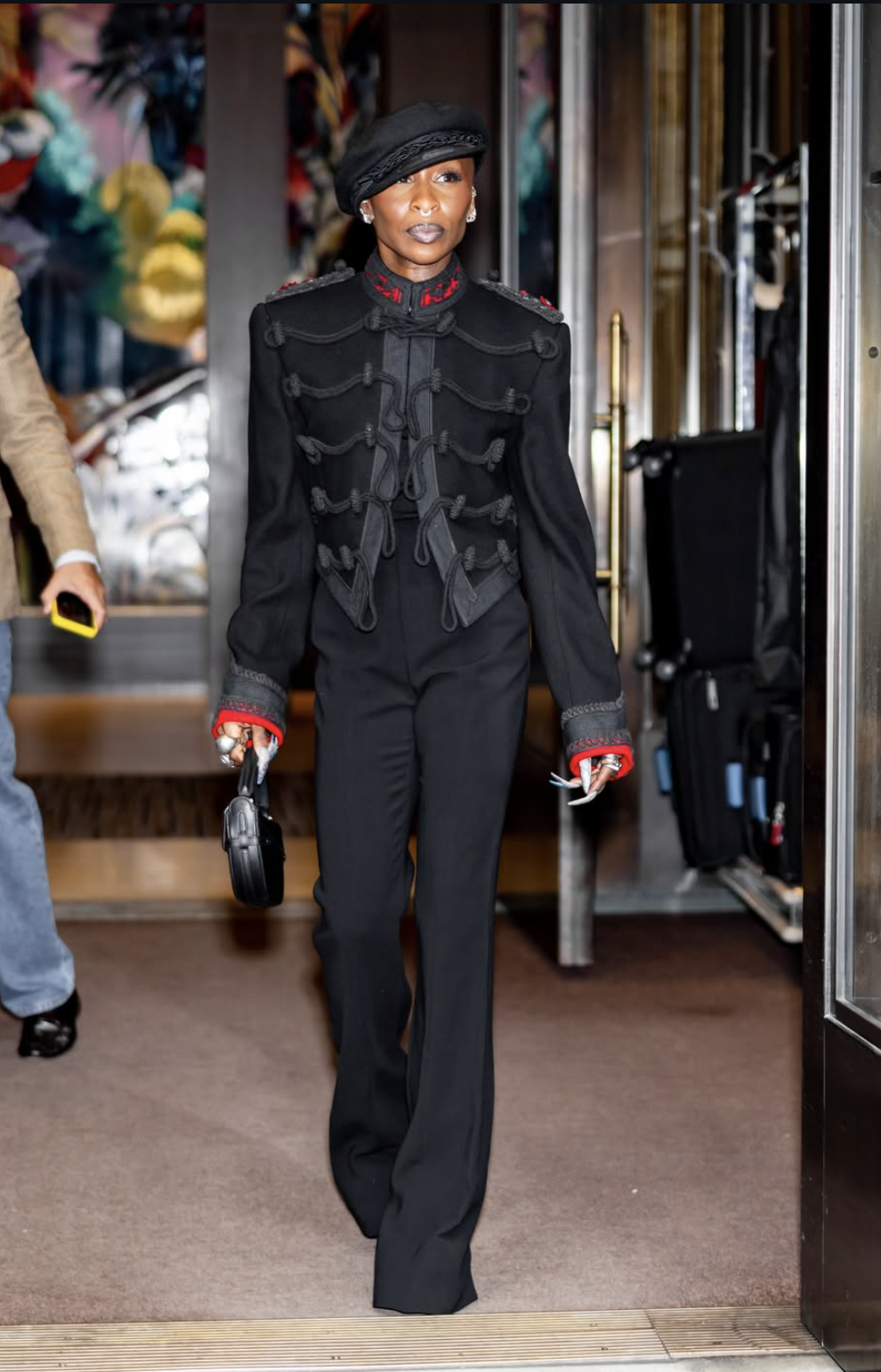 Cynthia Erivo wearing a black military-inspired jacket, tailored trousers and a black beret at Ralph Lauren.