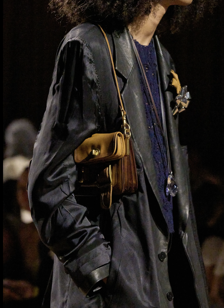 Long Coach trench coat with exposed lining details on the spring 2027 runway.
