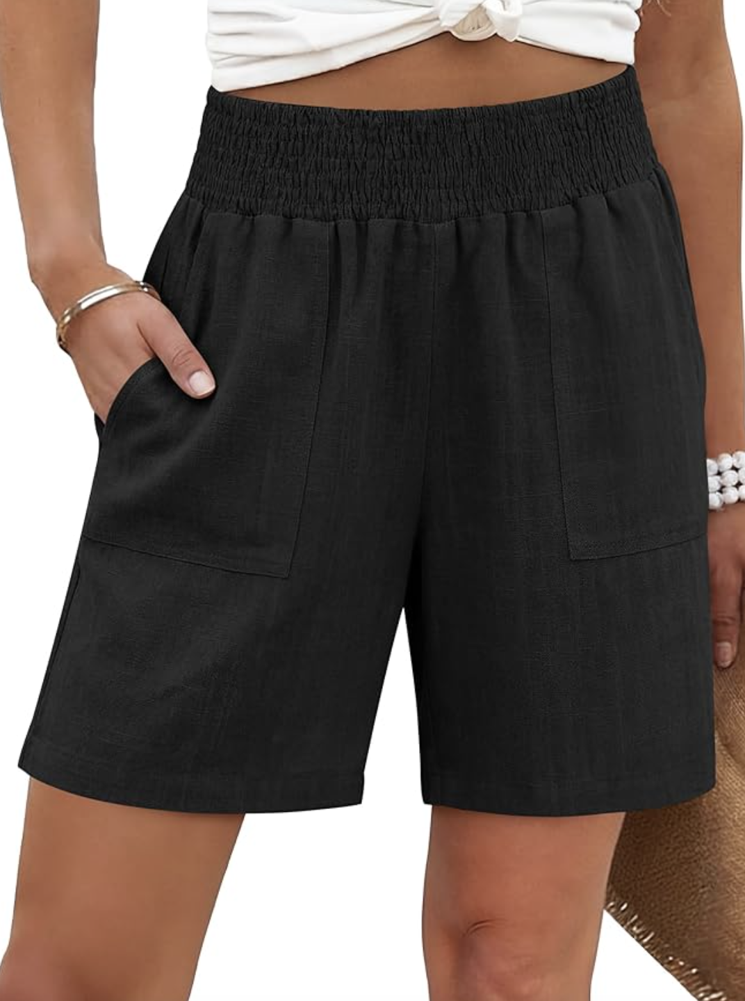 A pair of black high-waisted linen blend shorts with a smocked waistband and wide-leg fit.