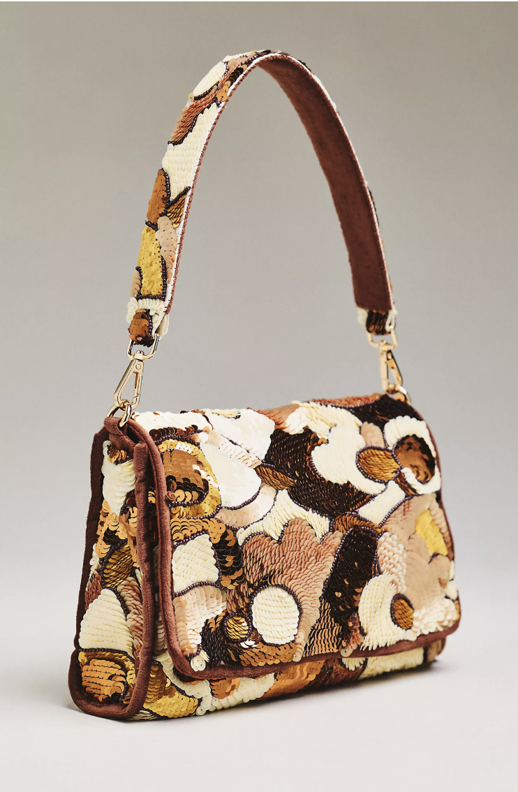 Embroidered shoulder bag worn with an oversized white shirt, relaxed trousers and loafers.