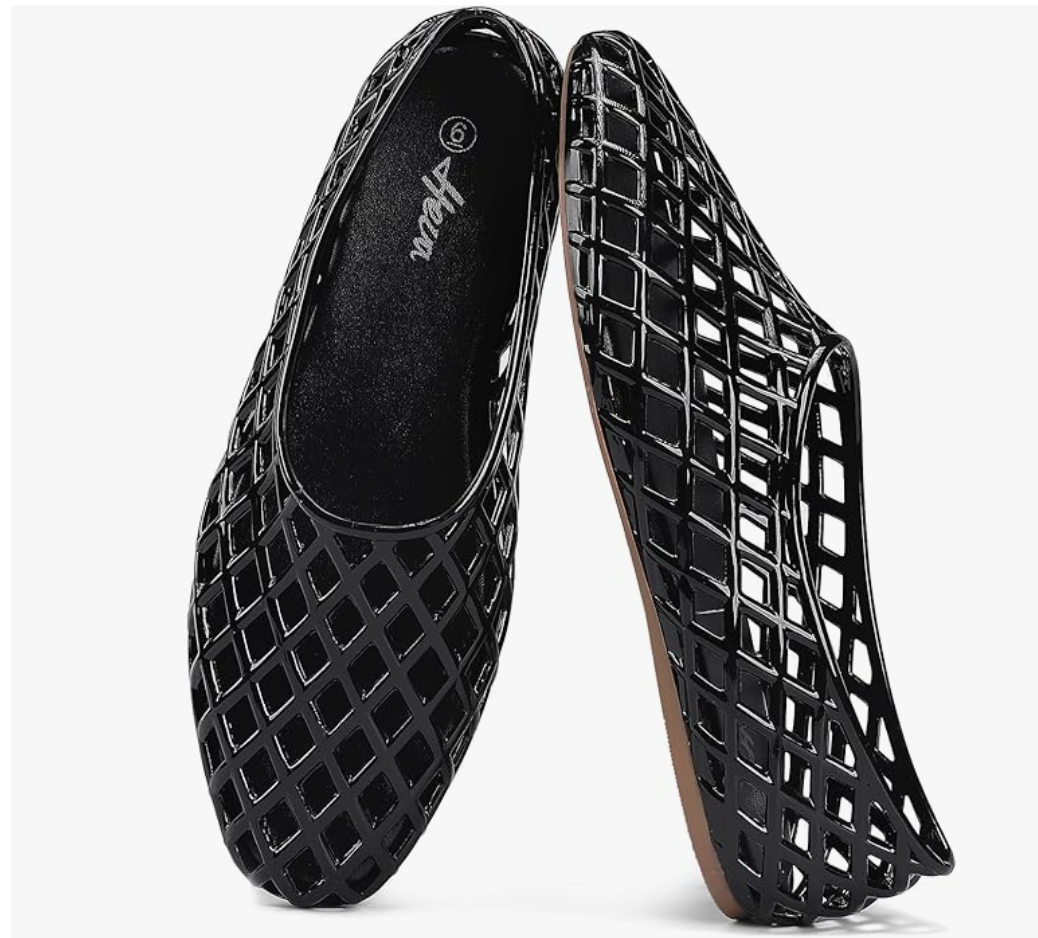 A close-up product shot of a pair of black woven lattice jelly Mary Jane flat shoes on a clean white background.