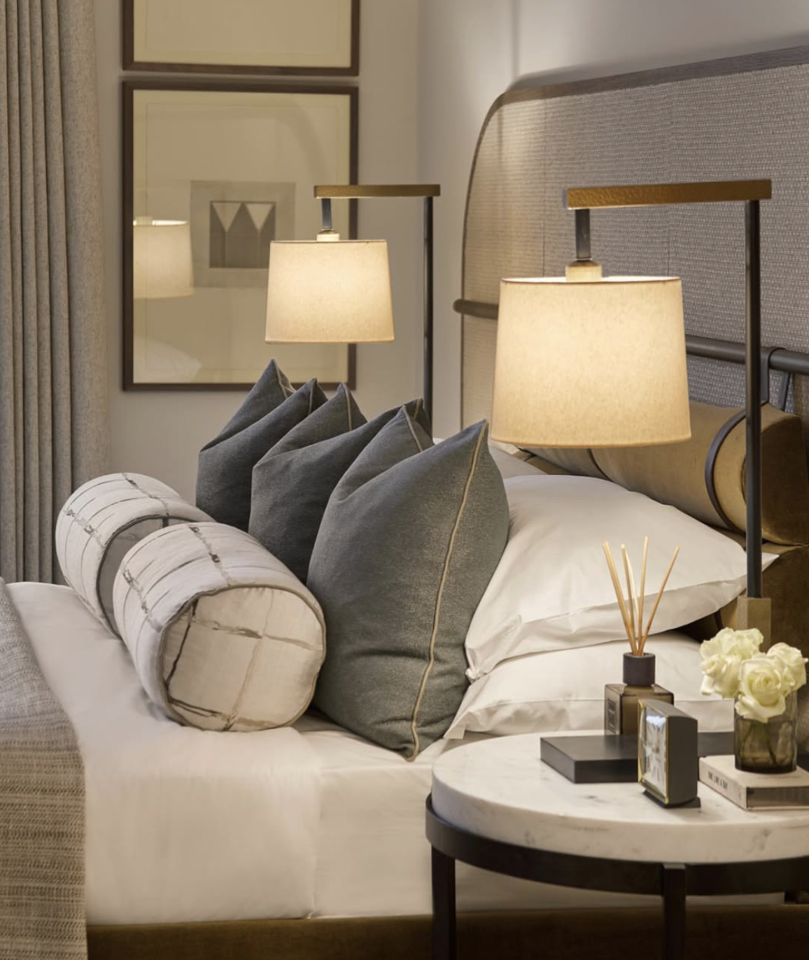Layered bedside lighting with lamp and wall sconce for a cozy bedroom