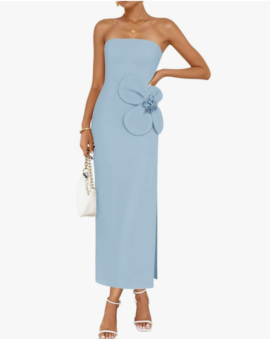 A woman wearing a cornflower blue strapless maxi dress with a 3D floral applique on the bust and a ribbed knit texture.