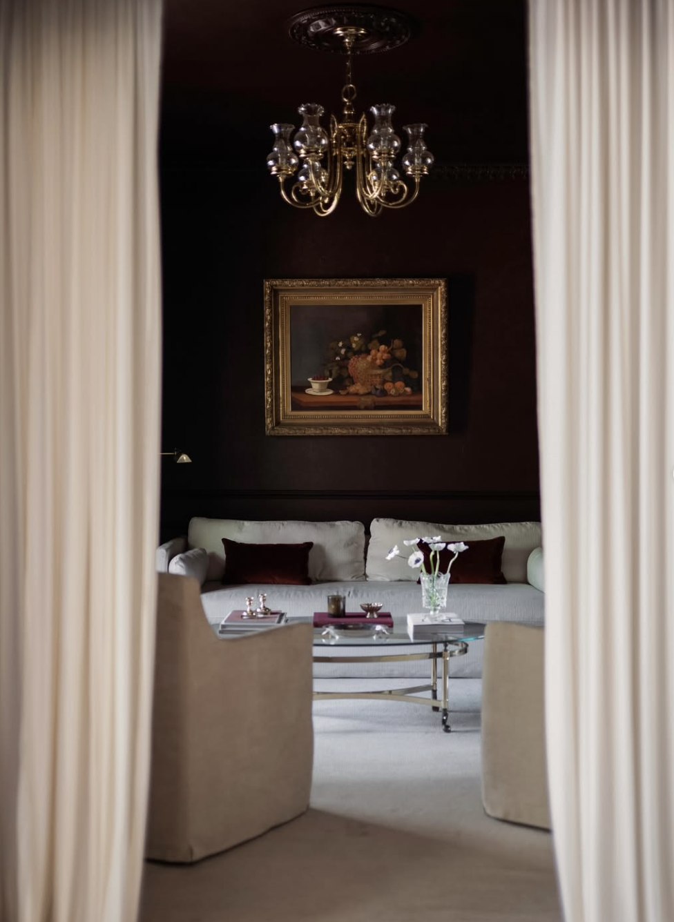 Warm mahogany and oxblood bedroom accents on pillows and lighting
