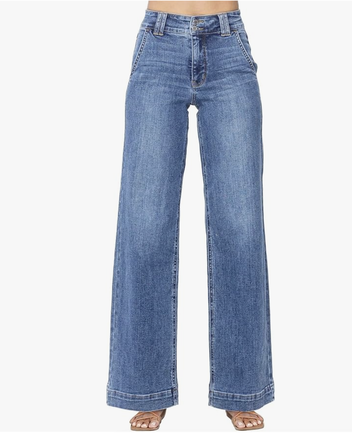 A close-up of medium-wash, high-rise wide-leg jeans featuring a double-stitched hem and front pocket detailing.