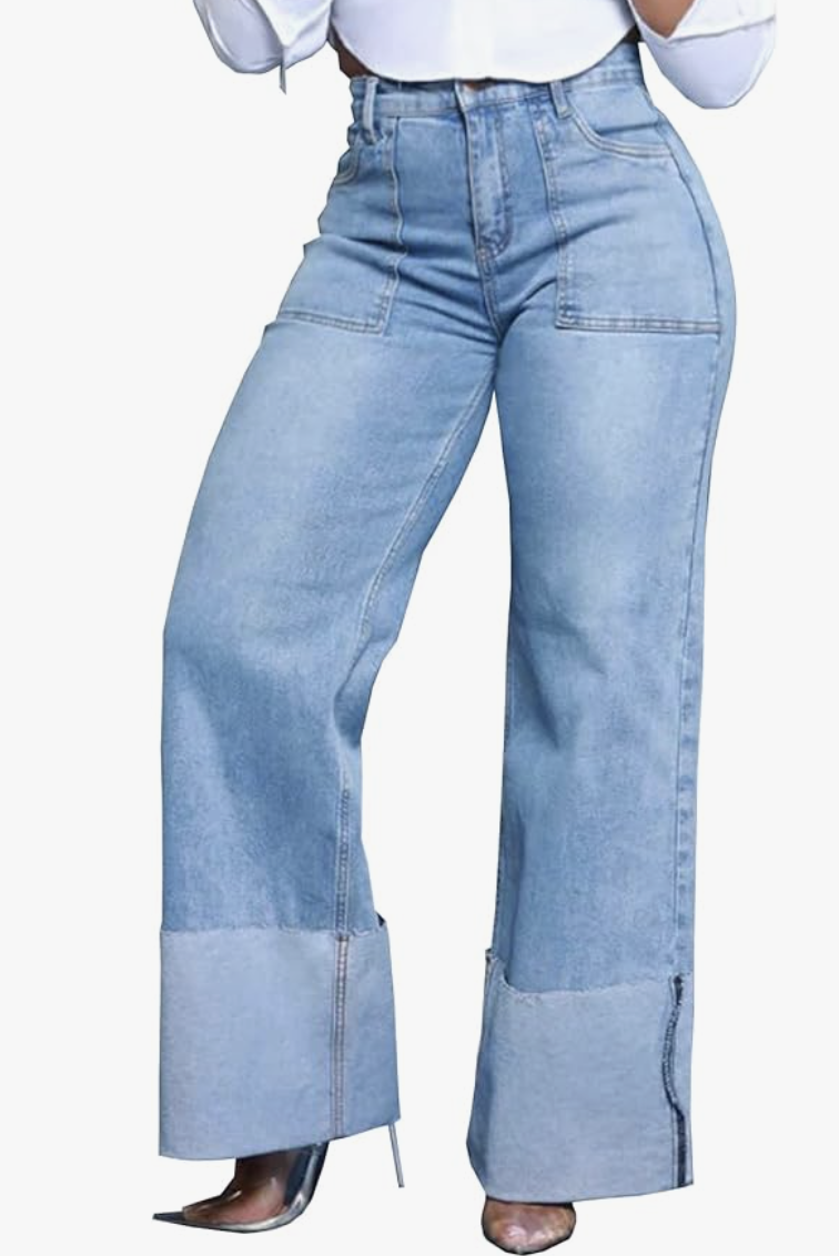 A person wearing KnoInt high-waisted wide-leg jeans with a dramatic thick cuff, styled with metallic silver pointed-toe heels to showcase a modern denim trend for hourglass figures.