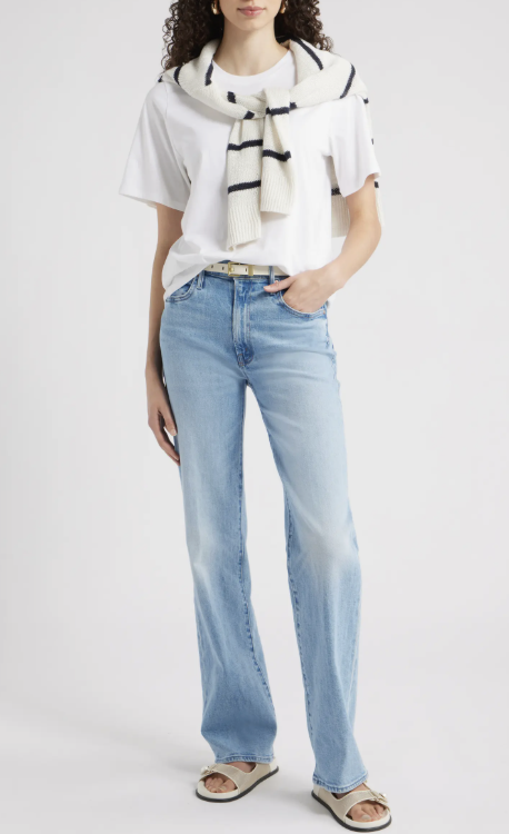 Product shot of Princess Polly Naylor mid-rise wide-leg jeans in light wash, styled with a white graphic t-shirt to show a relaxed and modern baggy jeans silhouette.