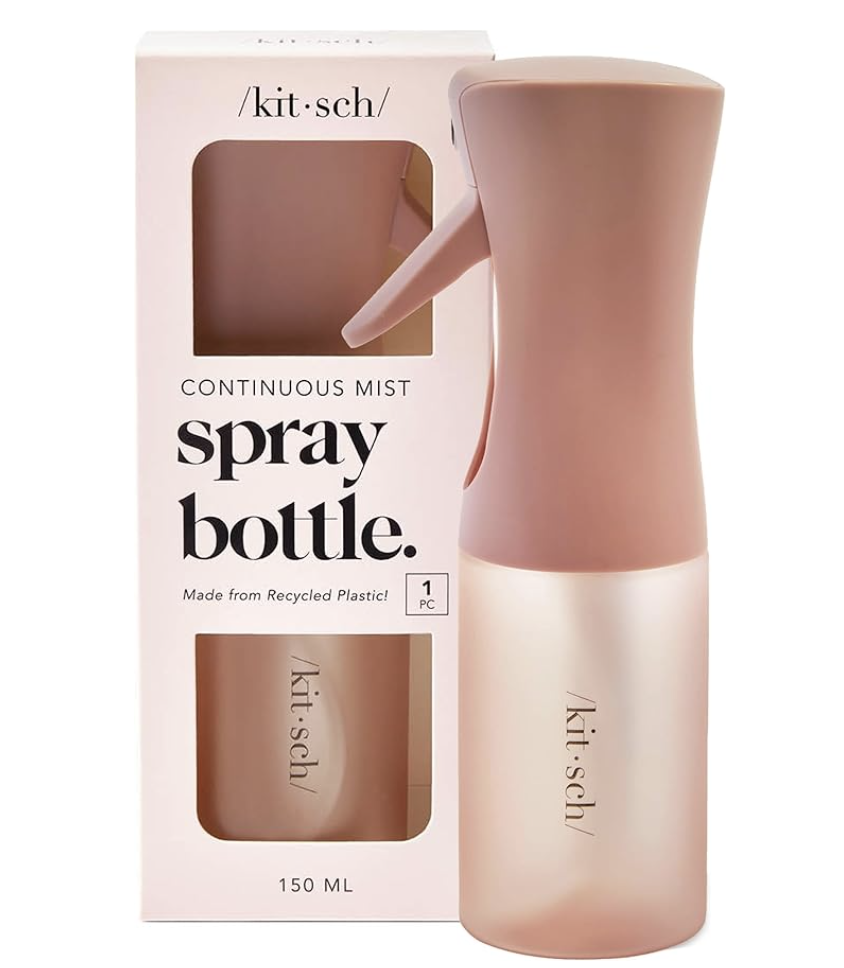 The blush pink packaging and matching spray bottle of a Kitsch continuous mist spray bottle against a light background.
