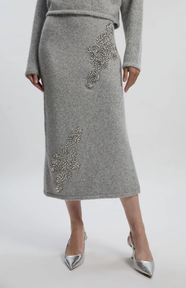 Woman wearing a Karen Millen grey wool embellished pencil midi skirt paired with silver metallic slingback pumps