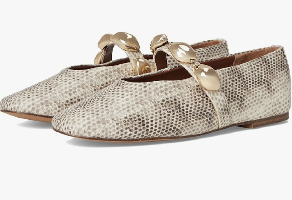 A pair of pointed-toe Mary Jane flats featuring a natural snake print, a slim ankle strap with a gold-tone circular buckle, and a low block heel, styled for a 50 plus spring capsule wardrobe.