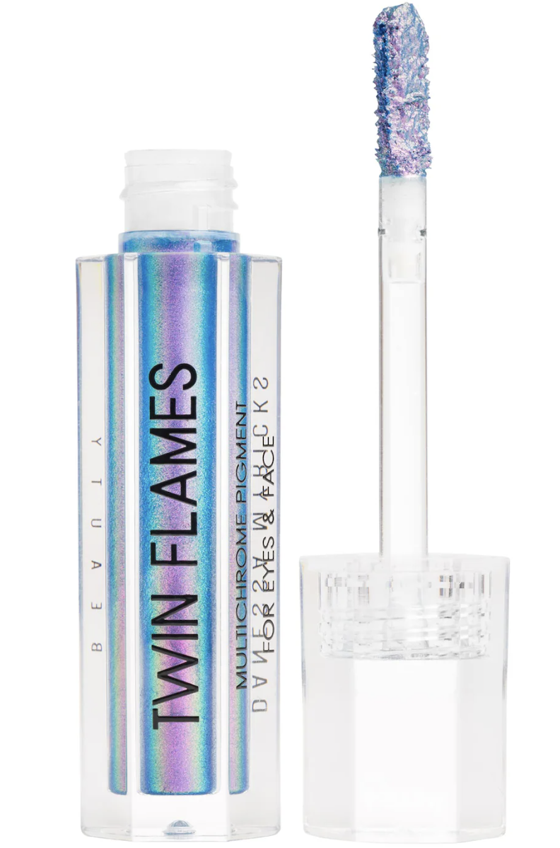 Danessa Myricks Beauty Twin Flames Multichrome Liquid Eyeshadow tube with wand applicator showing iridescent pastel shift pigments against a transparent background.