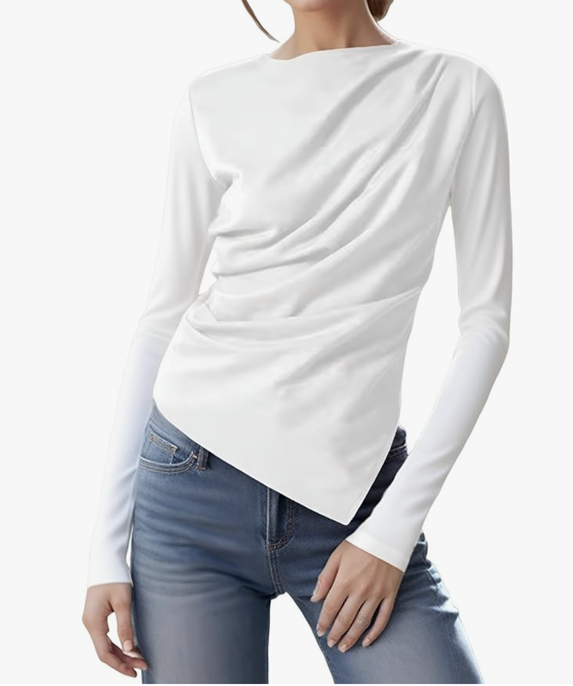 A white long-sleeve knit top featuring an asymmetrical neckline and ruched detailing, paired with blue jeans on a white background.