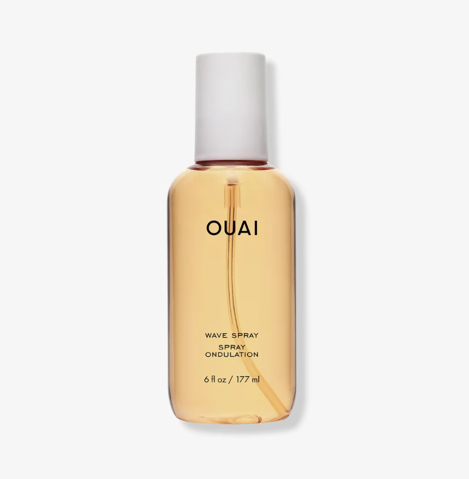 A bottle of OUAI Texturizing Wave Spray, used for a 2026 lazy girl hair routine to create effortless heatless waves overnight without using a curling iron.