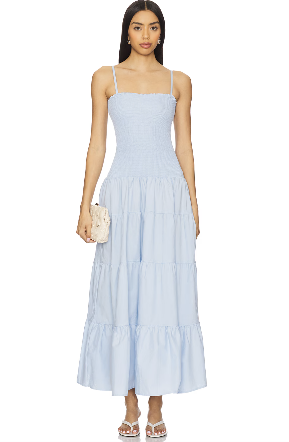 A woman wearing a light blue midi sundress with a tiered skirt and spaghetti straps, perfect for a Hawaii vacation.