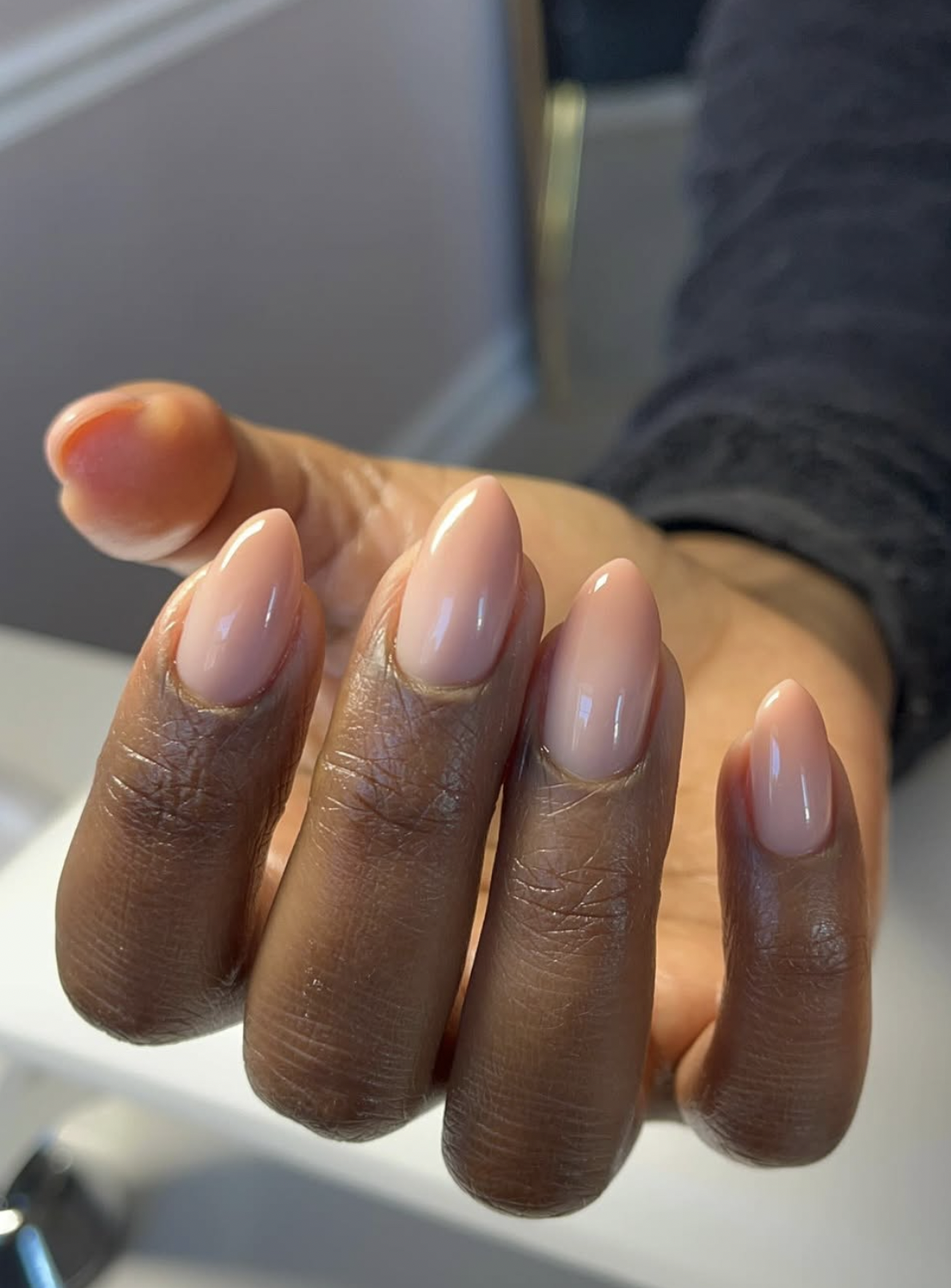warm caramel ombre nails manicure photographed close up on hands.