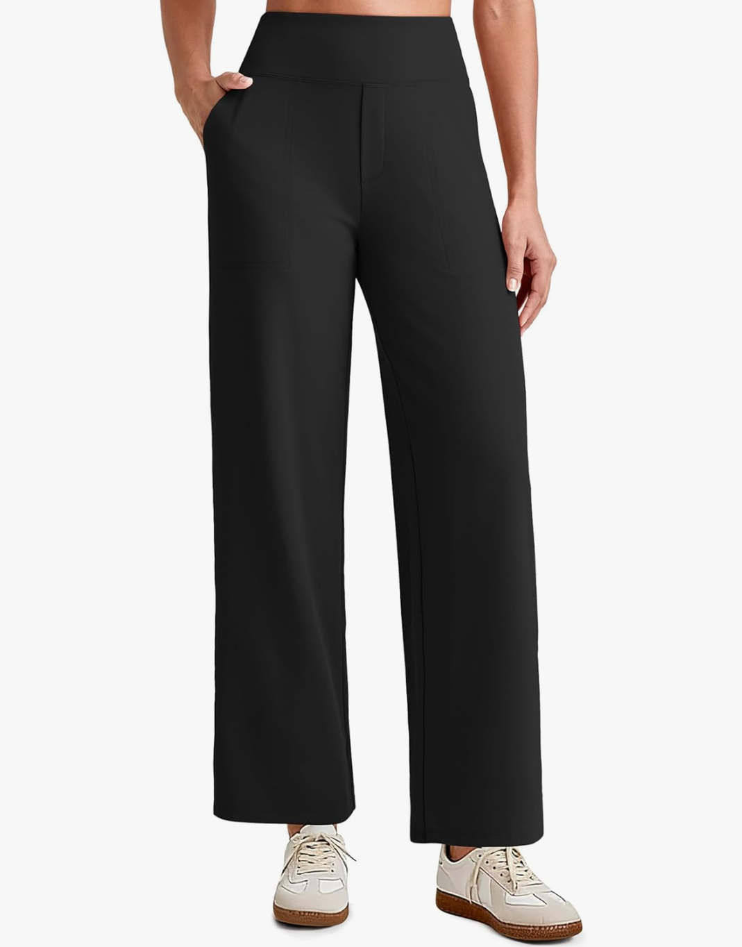 A close-up of a woman wearing black high-waisted cropped stretch pants with a smooth waistband and pleated front, styled for a polished spring capsule wardrobe.
