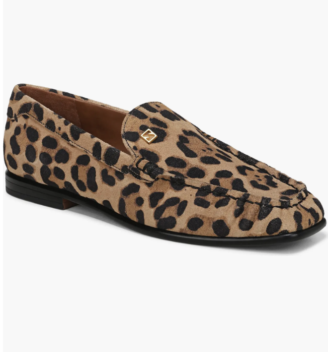 A pair of leopard print calf hair loafers with a black sole and a small gold logo detail on the side.