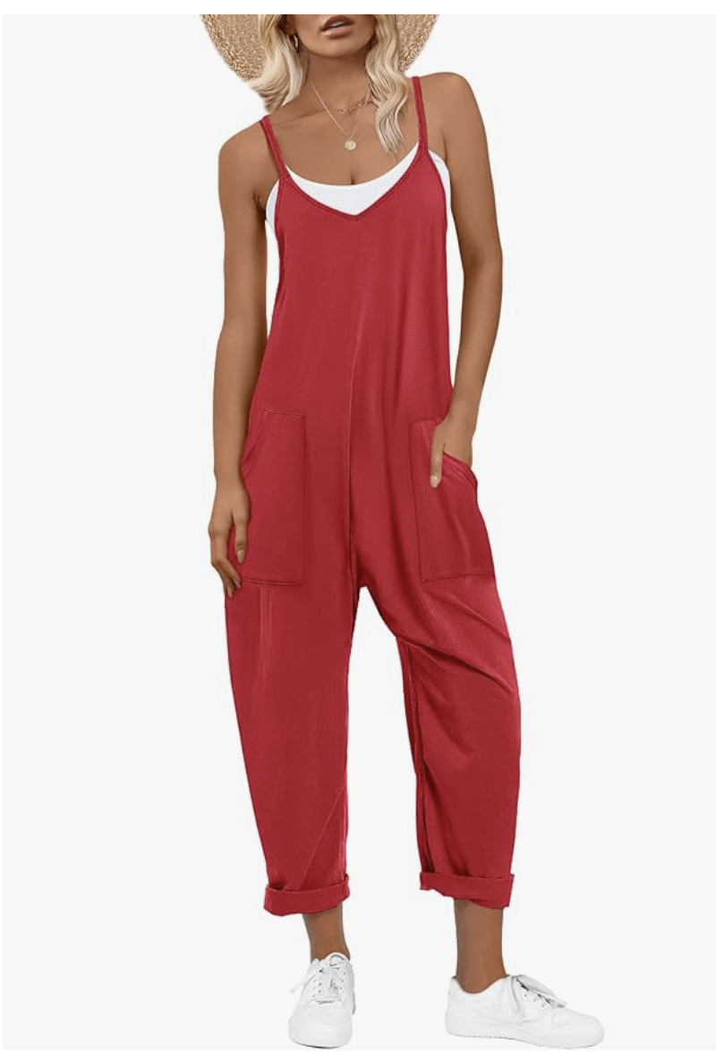Fashion editor wearing oversized red cotton summer overalls with large front pockets, demonstrating a comfortable and effortless 2026 casual outfit formula.