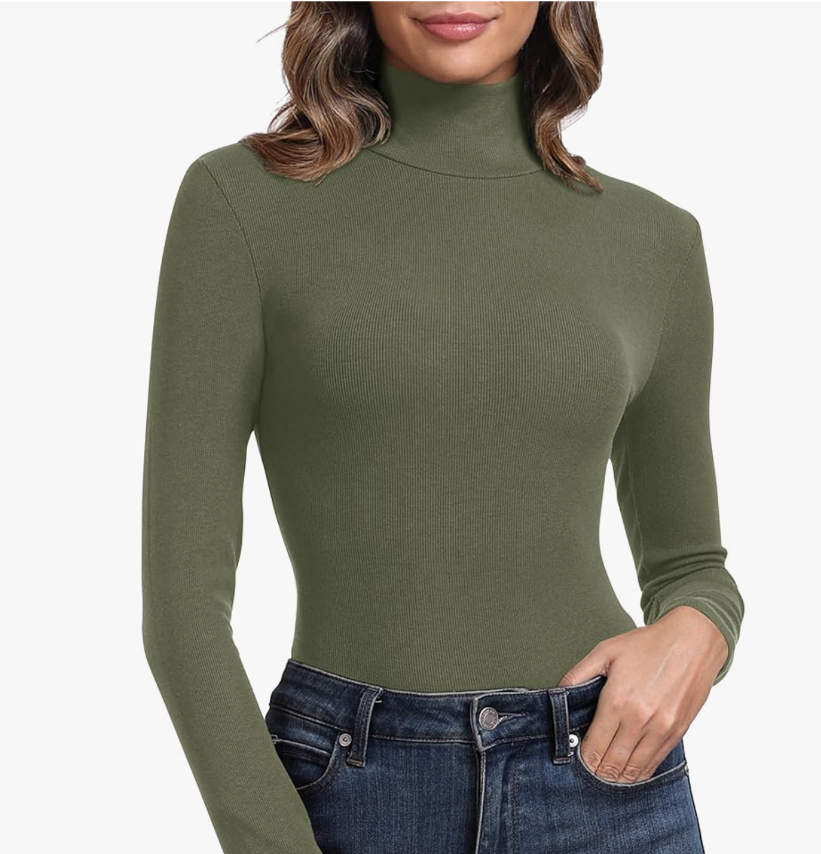 An olive green fitted turtleneck shirt paired with dark denim, demonstrating how earthy green tones perfectly complement brown trousers.