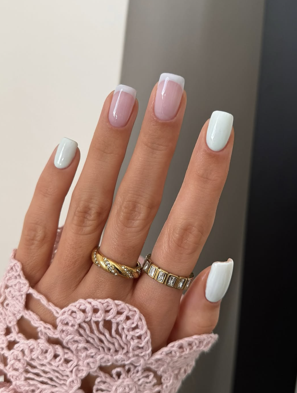 Short, elegant square nails with a glossy sheer nude base coat and clean, ultra-thin baby blue micro French tips.