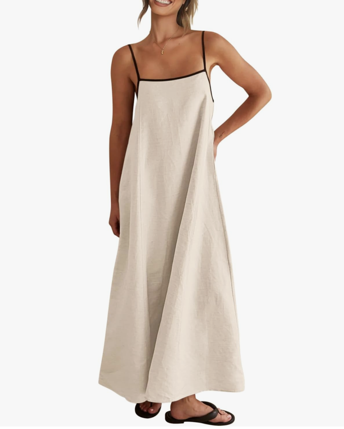 A woman wearing a tan linen-blend midi dress with thin black straps, styled for a summer outfit idea.