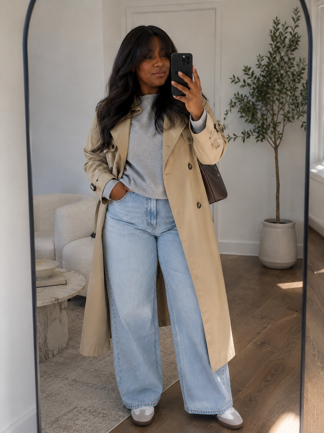 A gray sweatshirt under a trench styled for fall, featured in an Autum Love guide