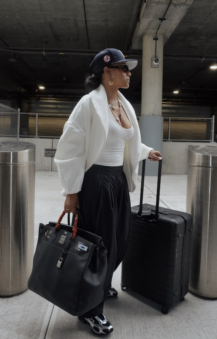 A white cardigan and black wide-leg pants.