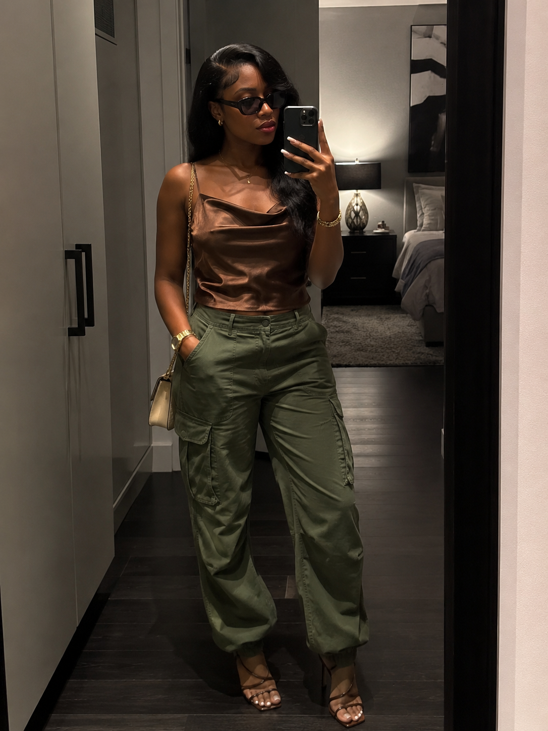 A pair of black low-waisted parachute cargo pants with an oversized wide-leg fit and adjustable drawstring waist and hem.