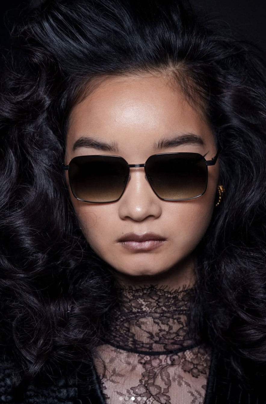 Close up of a model at the LaQuan Smith Fall/Winter 2026 show featuring the 'Just Smooched' blurred lip trend and sunglasses, shot by The Impression.