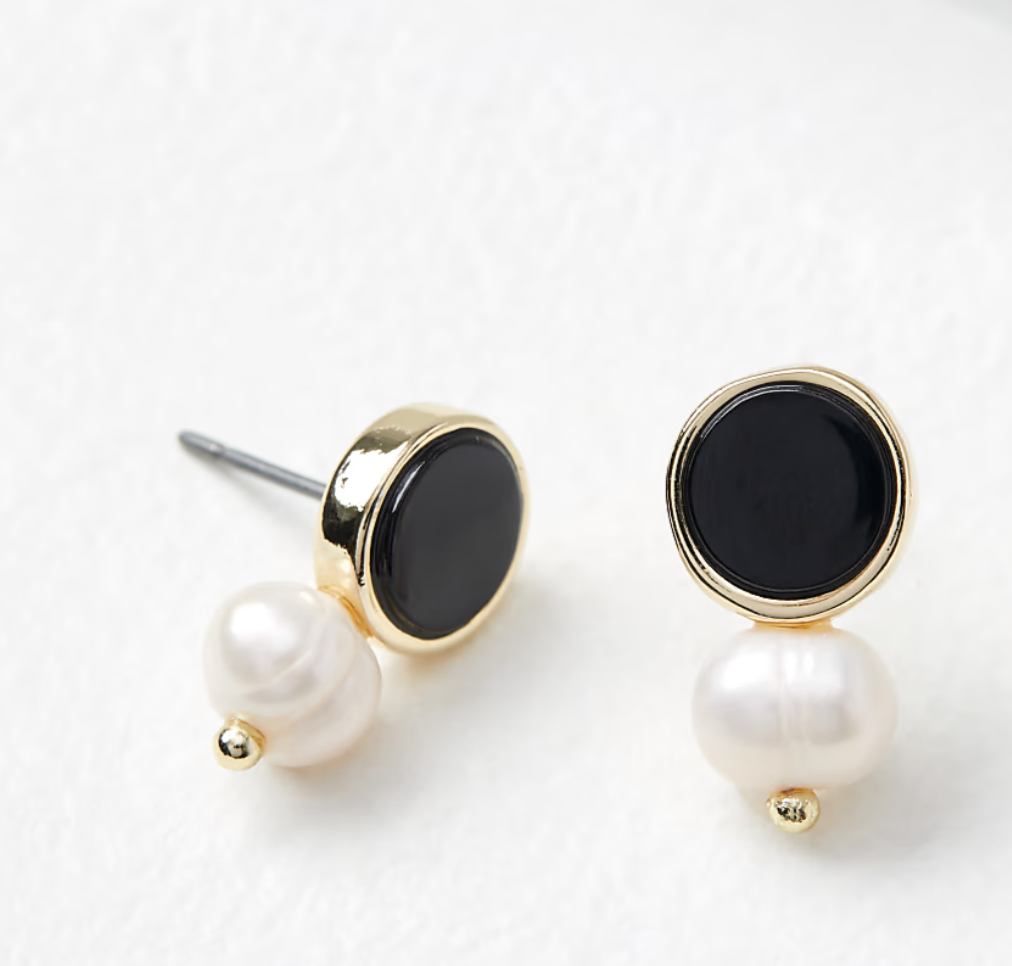 Pair of LOFT pearlized drop stud earrings on a plain background