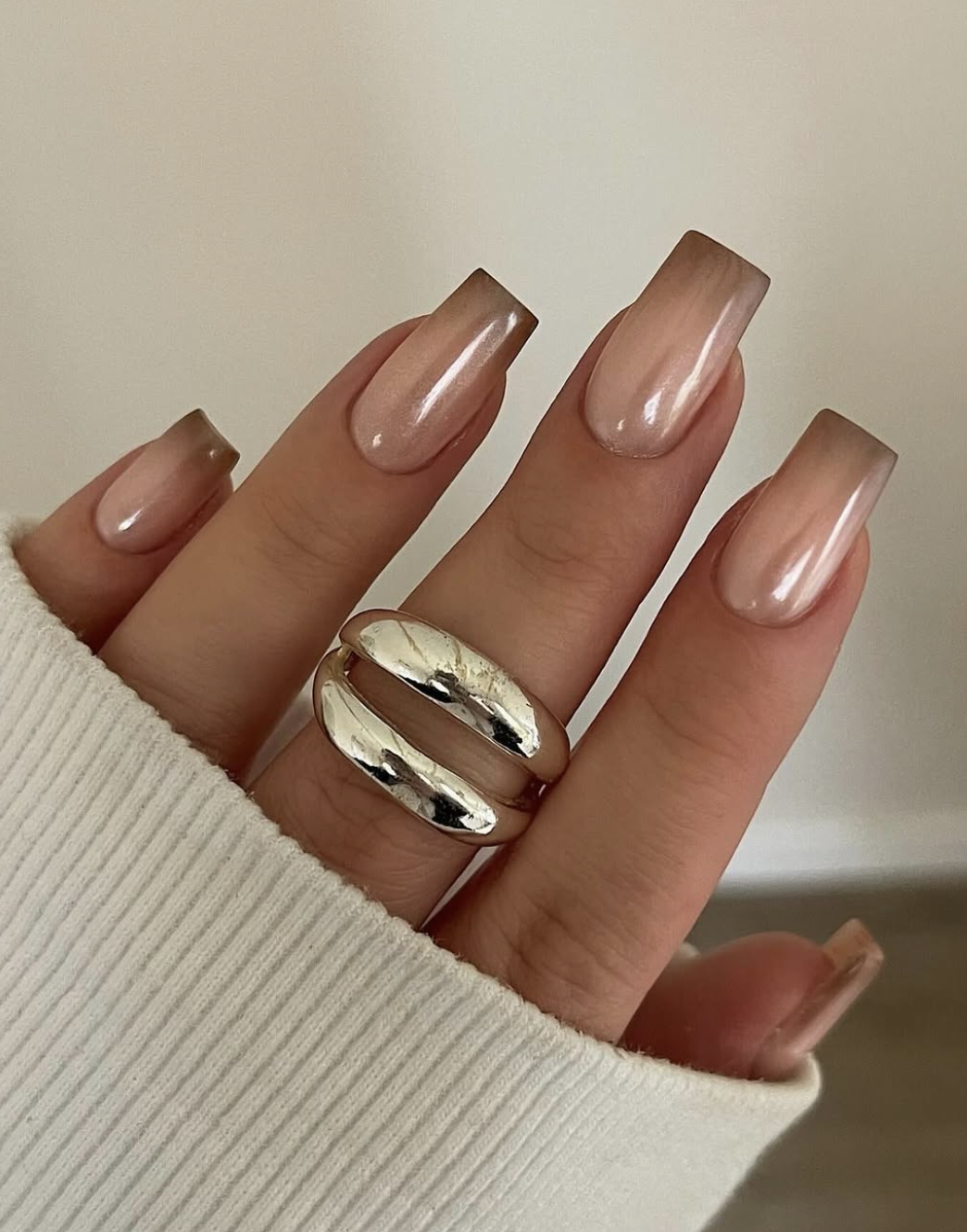 Close-up of caramel ombré french on neatly manicured hands