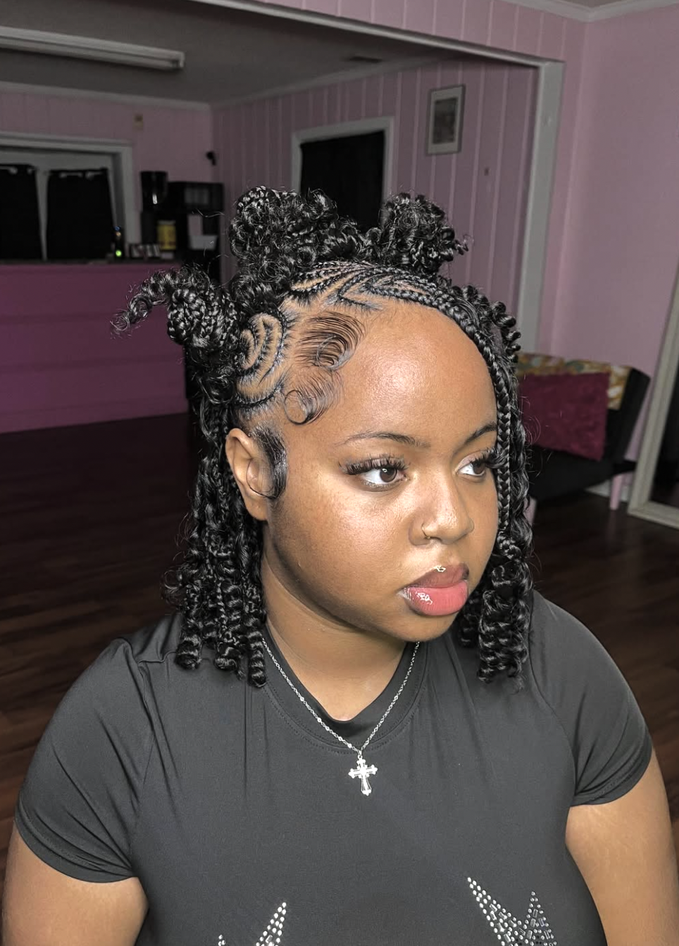 Braids wrapped into multiple Bantu knots arranged across the crown.