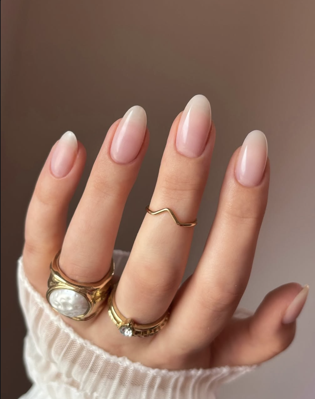 Short natural square nails with a clear, high-shine structured gel manicure.